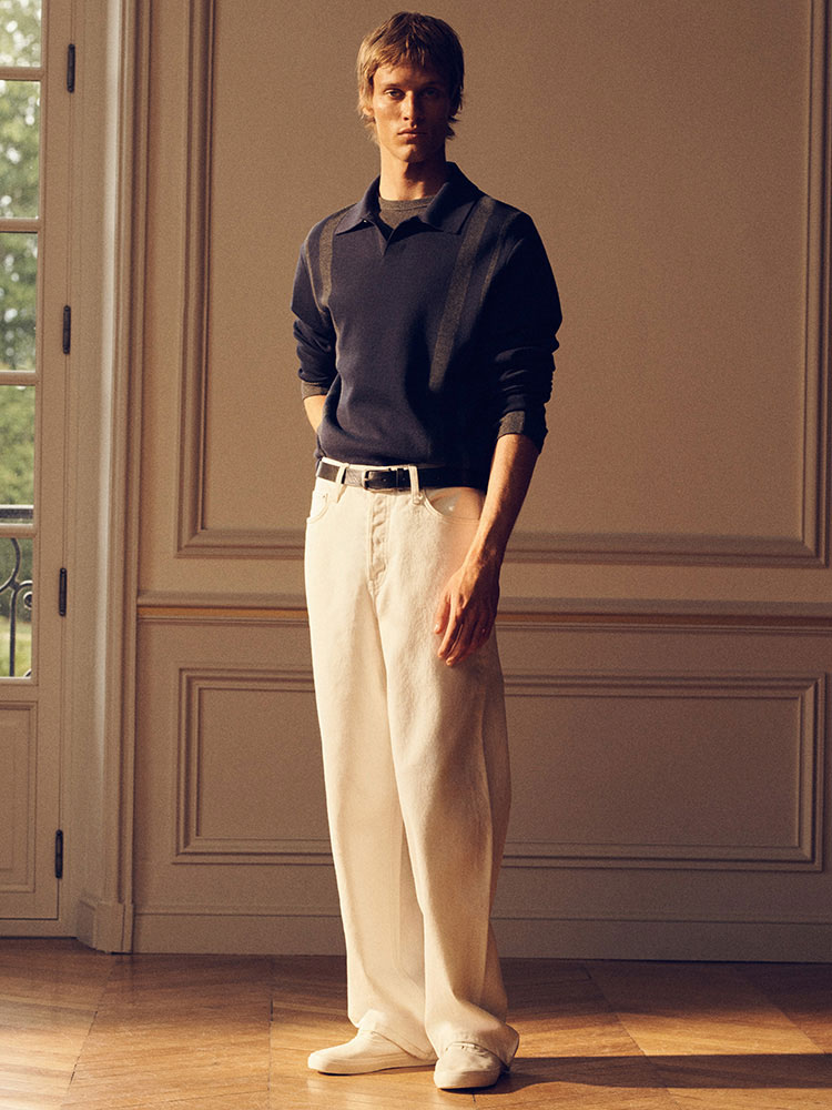 man wearing turtleneck standing on balcony